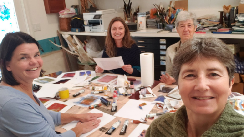 Alison Nicholls in an art workshop studio setting with 3 other people.